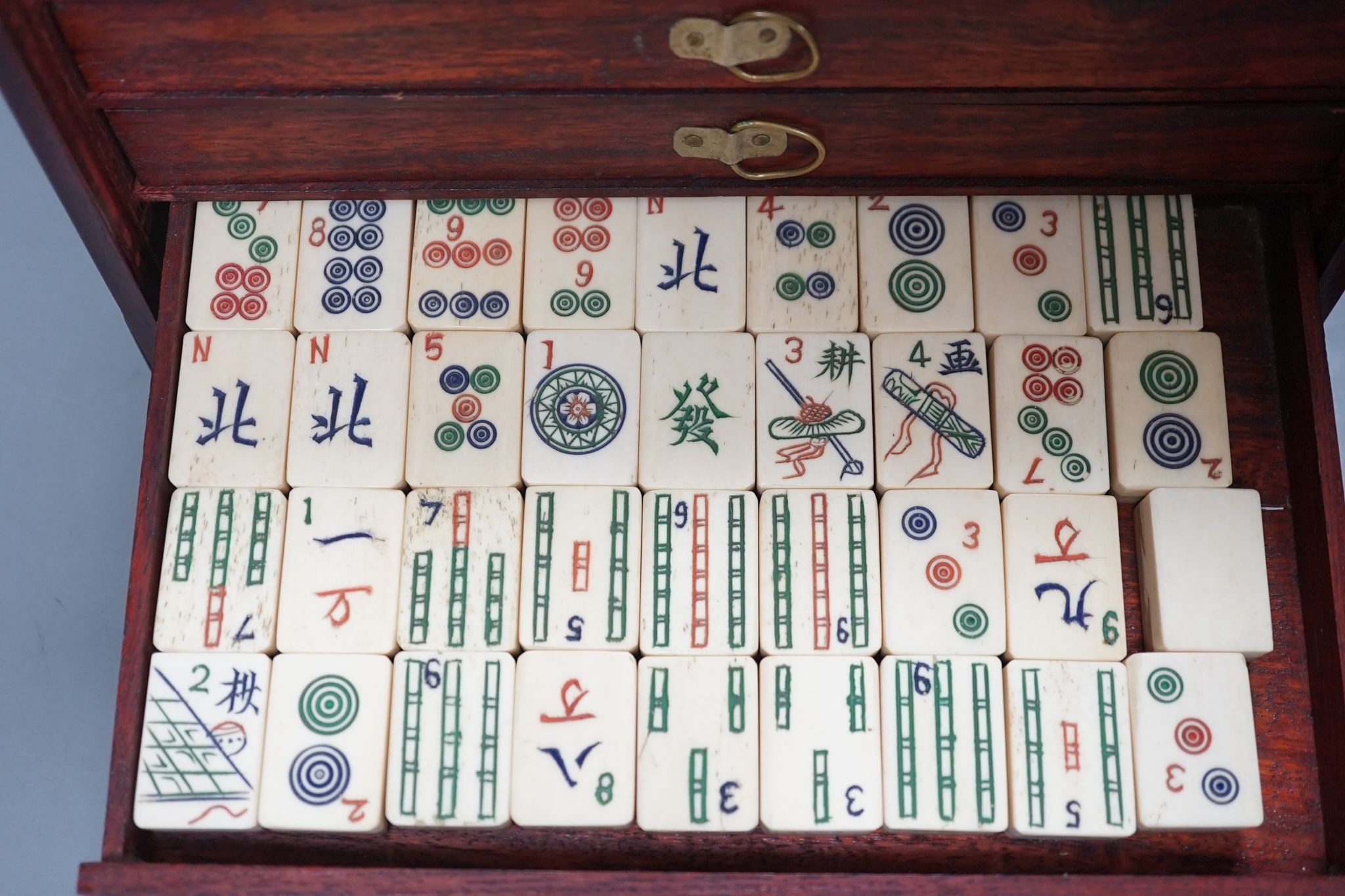 A MahJong set and a Chinese brass mounted card case., MahJong set, 15.5 cms high x 23.5 cms wide.